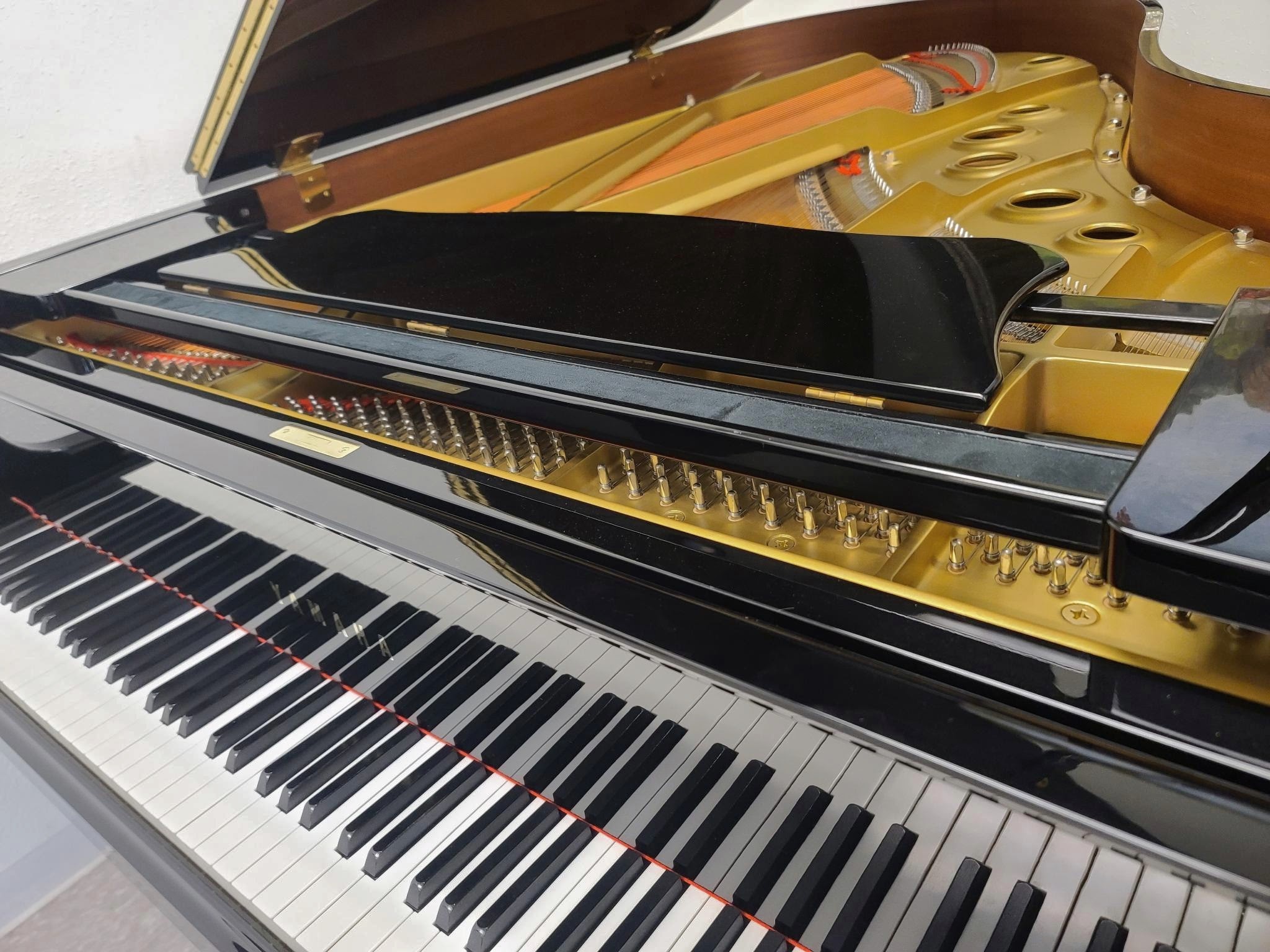 Beautiful Yamaha professional grand piano with action and strings showing.